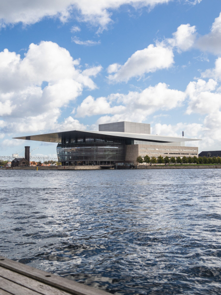 A vertical shot of the Copenhagen Opera House by the water captured in Copenhagen, Denmark